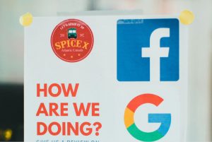 Dental reception desk showing a tablet with automated patient review prompts integrated with ClearDent.